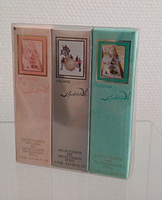 deux boîtes de parfum posées sur une table en verre