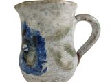 a blue and white vase with a handle on a white background