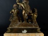 bronze sculpture of a group of people on a marble base