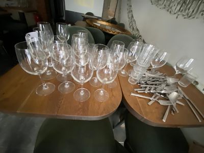 many glasses and spoons on the table ready to be served