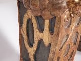 a close up of a vase with a bird on it