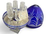 a blue glass bowl with glasses on it next to a blue glass bowl with glasses on it