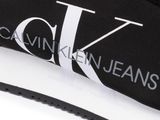 a close up of a pair of black sneakers with a logo on the sole