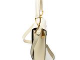 beige and black handbag on white background with strap