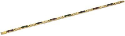 a close up of a gold bracelet with green and red beads