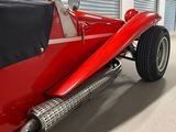 an image of a red and black car in a garage
