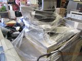 many appliances that are wrapped in plastic in a store