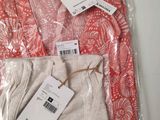 three pairs of women ' s pants in a plastic bag