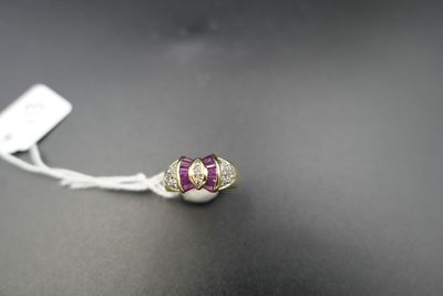 a close up of a silver ring with a purple stone