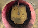 a clock that is sitting in the middle of a hole