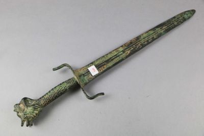 a green and black dagger with a lion head on it