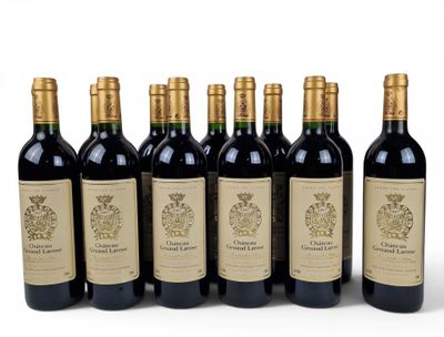 six bottles of wine are lined up in a row on a white surface