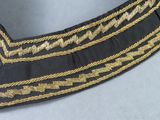 a close up of a black and gold belt on a table