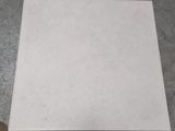 a piece of paper sitting on the floor next to a pair of scissors