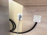 a black and white cord connected to an electrical outlet