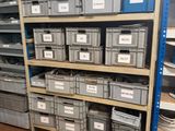 many bins and boxes on the shelves in the warehouse