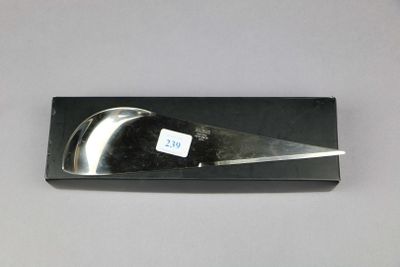 a black box with a knife in it on a table