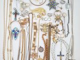 a group of various necklaces and bracelets on a white surface