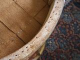a close up of a chair with a seat made out of wood