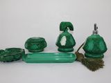 a green bathroom set that includes a soap dispenser, toothbrush holder, soap dish, and a brush holder