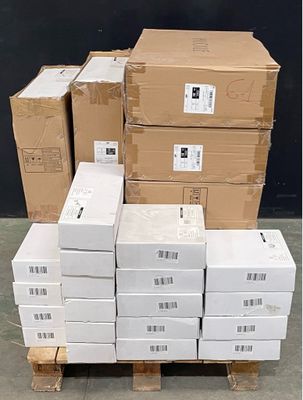boxes stacked on a pallet in front of a black wall