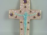 purple and gold cross with a crucift on it on a white surface