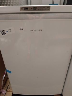 a white refrigerator that is sitting in a room