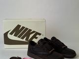 black nike sneakers with pink ribbon and shoe laces on a white surface