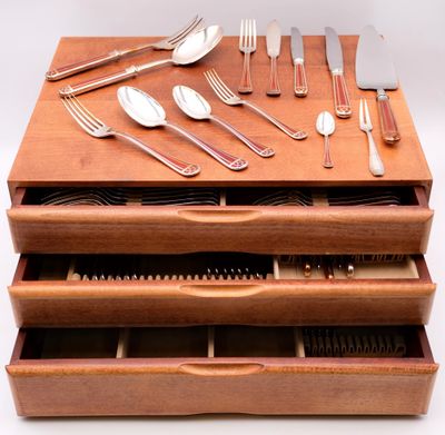 a wooden drawer with silverware and silverware in it