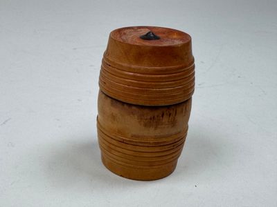 a small wooden barrel that is sitting on a table