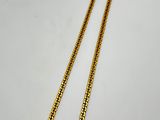 a gold necklace with an evil eye pendant on it