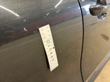 a sticker on the door of a car that has a sticker attached to it