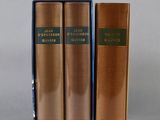 two books are sitting side by side on a gray surface
