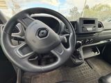 a steering wheel and dashboard of a vehicle in a parking lot