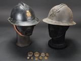 two helmets and coins are sitting on top of a mannequin head