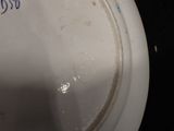 a white toilet with blue writing on it and a black background