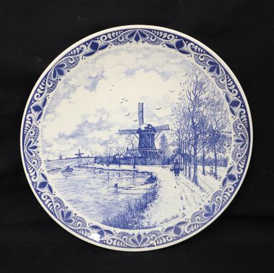 a blue and white plate with a windmill on it