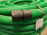 a green hose that has been wrapped up on the ground