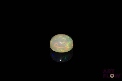 an image of a white fire opal in the dark
