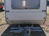 a small trailer that is parked on the side of the road