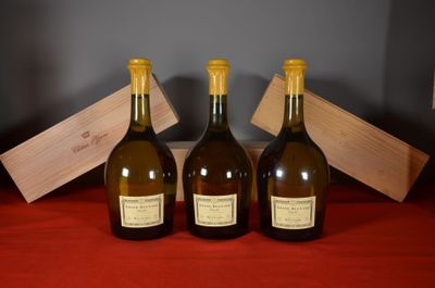 three bottles of wine sit on a red cloth next to a wooden box