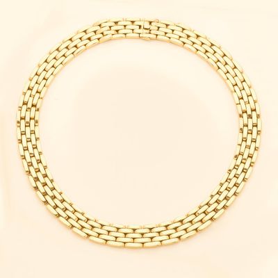 a close up of a gold chain bracelet on a white background
