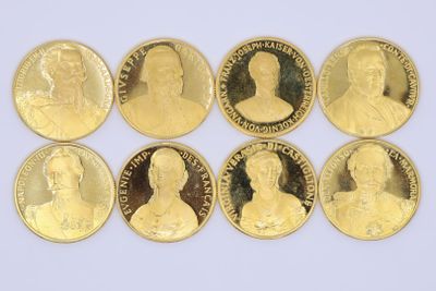 six gold coins with portraits of people on them on a white surface