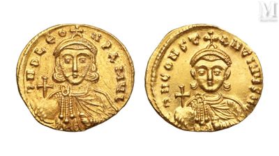 a gold coin with a portrait of a man and a woman on it