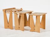 three wooden stools sitting next to each other on a white surface