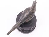 statue of a bird on a black base on a white background