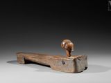 an old wooden hammer with a wooden handle on a gray background