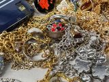 a pile of gold and silver jewelry on a table
