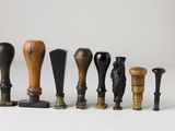 several different types of wood and metal objects on a white surface