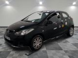 une photo d'une petite voiture noire recouverte d'autocollants